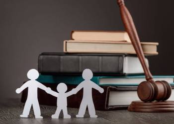 Paper people chain, books and judge's gavel. Law, family politics and gay marriage legalization.