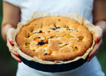 delicious apple pie in the hands of the cook