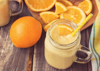 Orange fruit smoothie in the glass jar