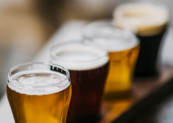 Close-up shot of a variety of beers, also known as a beer flight, as served in a microbrewery.