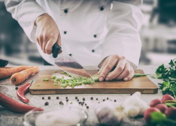 The chef slicing vegetables.