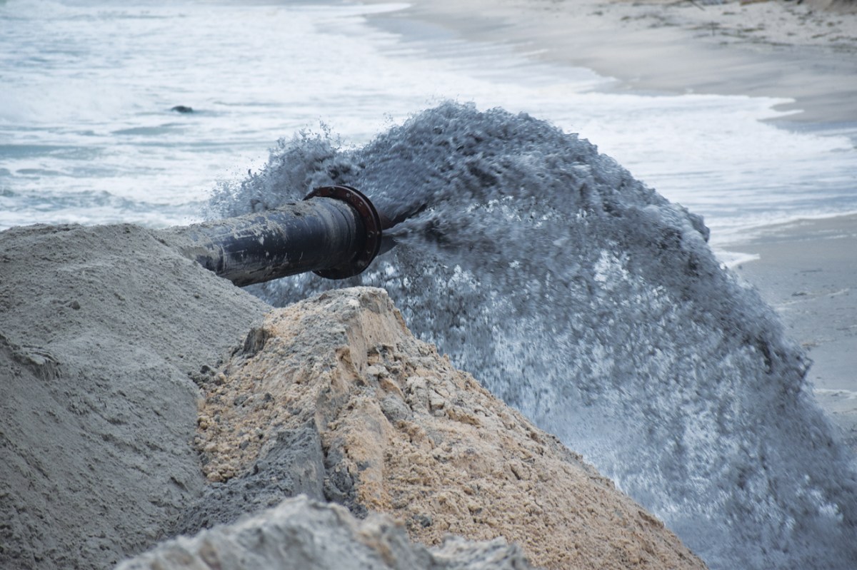 A slurry of sand pumped on a Hamptons beach from a dredge ship. Photo by James J. Mackin