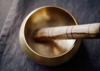 Bronze tibetan singing bowl with wooden stick. Sound healing, sound bath therapy in the Hamptons