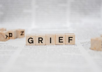 Grief Word Written In Wooden Cube - Newspaper