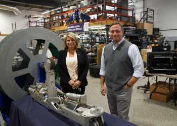 Jodi Giglio standing next to Greg Penza, founder and CEO of ULC Robotics, and a CISBOT robot.