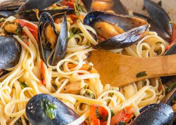 Homemade pasta with mussels in a large frying pan. Linguine with shellfish and vegetable sauce