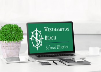 Modern workplace with laptop on table indoors. Westhampton Beach School District on screen