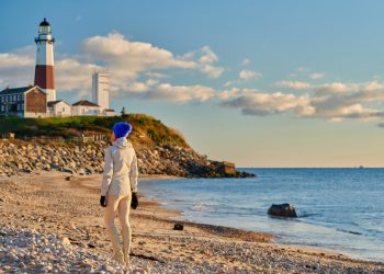 Woman tourist at the beach near Montauk Lighthouse