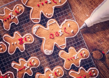 Decorating gingerbread Christmas Cookies with colorful icing