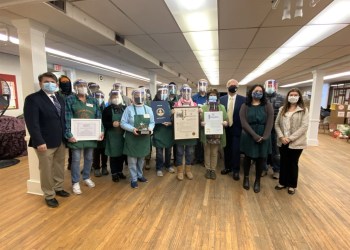 Evie Rammuno and fellow Sag Harbor Community Food Pantry volunteers receiving the Community Service Award and certificates of recognition.