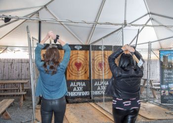 Caitlin Buthmann and Lexi Martone throwing axes