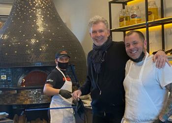 Michael Brunetti with his team in front of his wood-burning oven, imported from Naples.