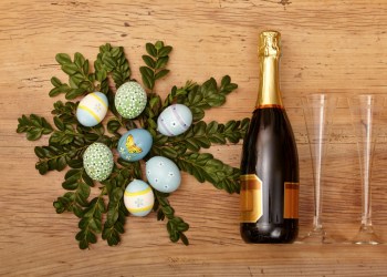 Easter decoration, champagner bootle and champagne glasses on wood