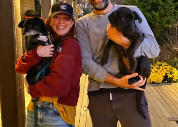 Julianne Moore holding her dog Milly and her husband Bart Freundlich holding Hope, the dog they adopted from Gimme Shelter.