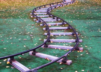 children’s railway on artificial lawn in an autumn park