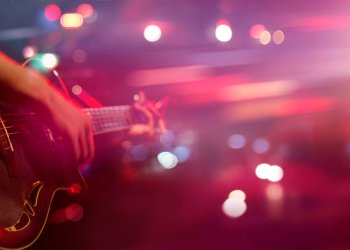 Guitarist on stage for background, soft and blur concept