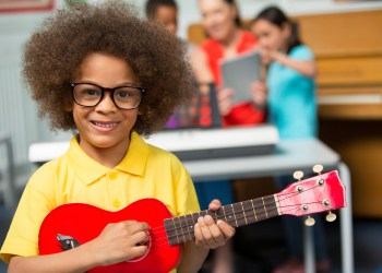 Young Boy Playing Ukulele