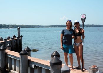 Evelyn O'Doherty and Gina Bradley help Stand Up for the Ocean paddle race