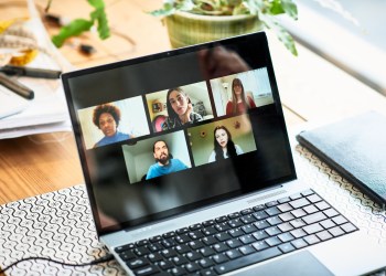 Five faces on laptop screen during video conference