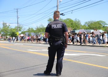 A Riverhead police officer watching the June 13, 2020, Black Lives Matter protest, which, like the governor’s call for police reform, was a direct response to the May 25 killing of George Floyd by a Minneapolis police officer