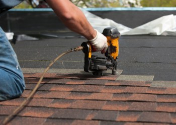 roofers installing new roof on house