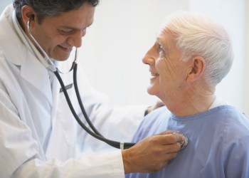 Doctor examining patient with stethoscope