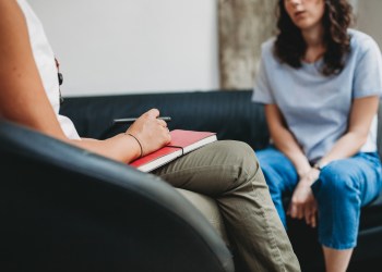 Psychotherapy session, woman talking to his psychologist in the studio - do you choose medication or hospitalization?