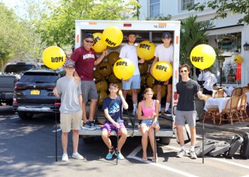 Coach Eddie Arnold, Jacob Warden, Jake Cook, Evan Simioni, Dylan Koszalka, Amanda Koszalka, Andrew Souhradh helped shops set up balloons for the Week of Hope and Race of Hope