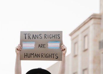 Transgender woman at gay pride protest holding transgender flag banner - Lgbt celebration event concept