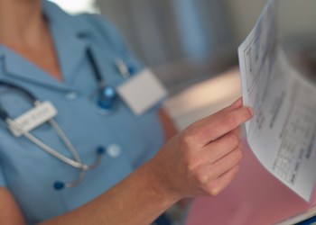 Nurse looking at patients medical chart