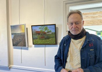 John Melillo with his paintings at an East End Arts member show