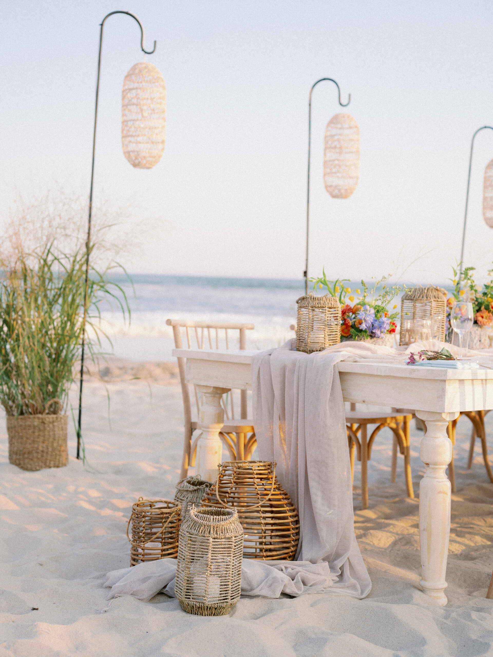 An SDPR Event Shoppe wedding rehearsal dinner arrangement on the beach