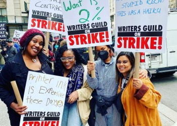 Writers strike Strikers with their picket signs