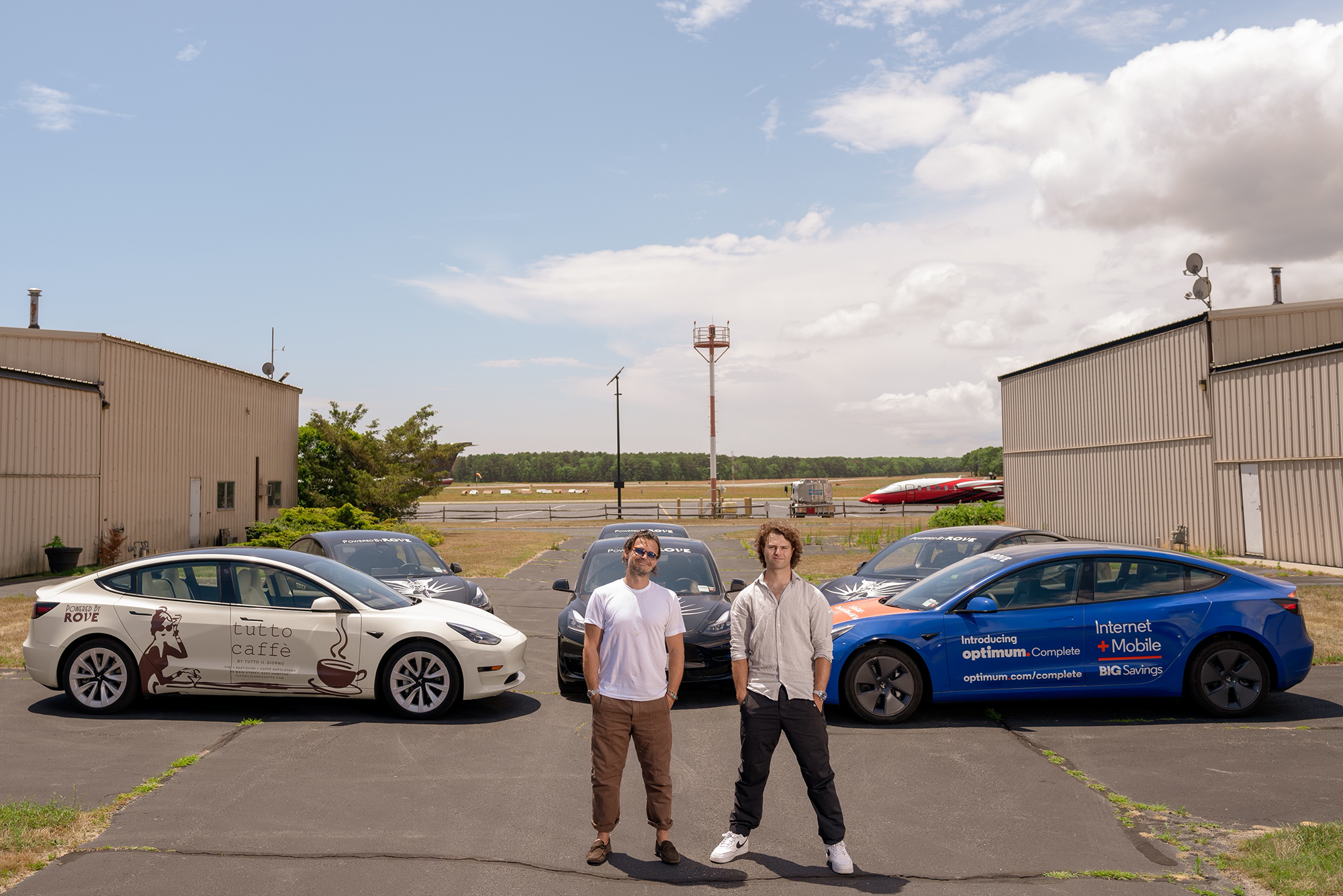 Rove owners Jack Brinkley Cook and Gianpaolo de Felice with five Teslas from the Rove fleet of 15