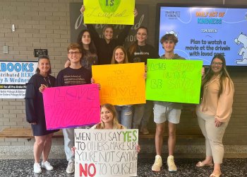 Members of Riverhead High School's Healthy YOUniversity with posters from their positivity campaign