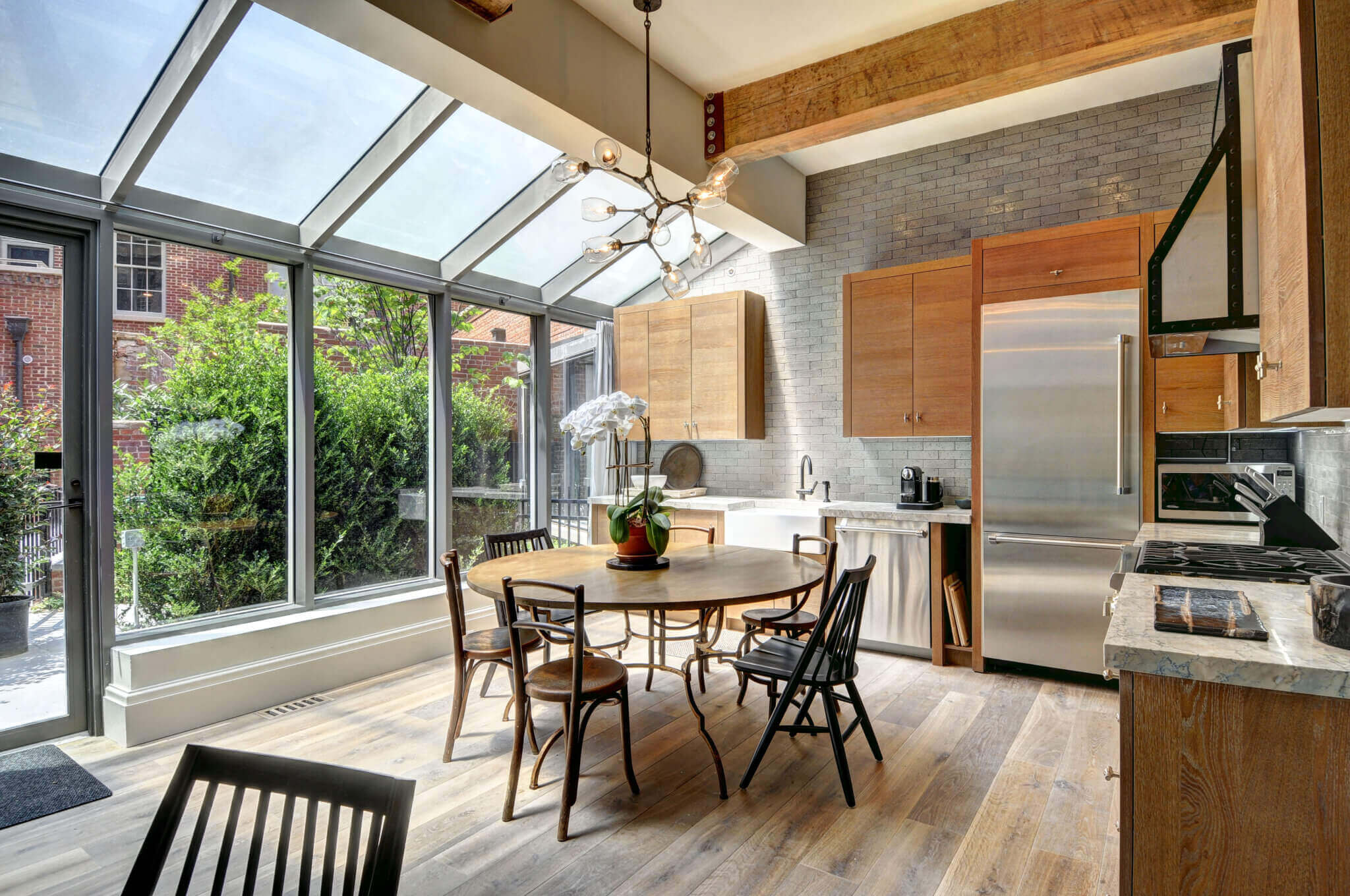 The glassed-in kitchen solarium also serves as the entrance to this condo unit. Courtesy of the CeeJack Team