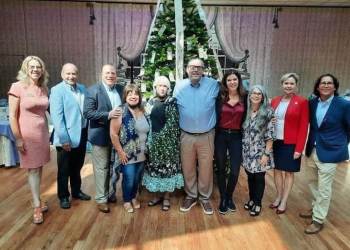 Last year’s fundraiser for Gabriel’s Giving Tree enabled the nonprofit to help many families with overdose funeral expenses. Here, attendees stand in front of the Angel Tree, which has ornaments with the faces and names of those lost to the opioid epidemic.