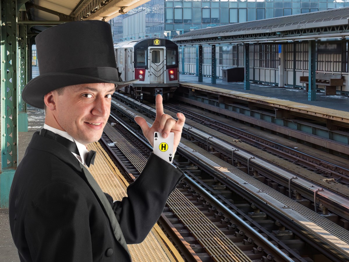 New York subway train arriving at outdoor covered platform among highrises on cold day