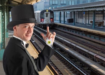 New York subway train arriving at outdoor covered platform among highrises on cold day