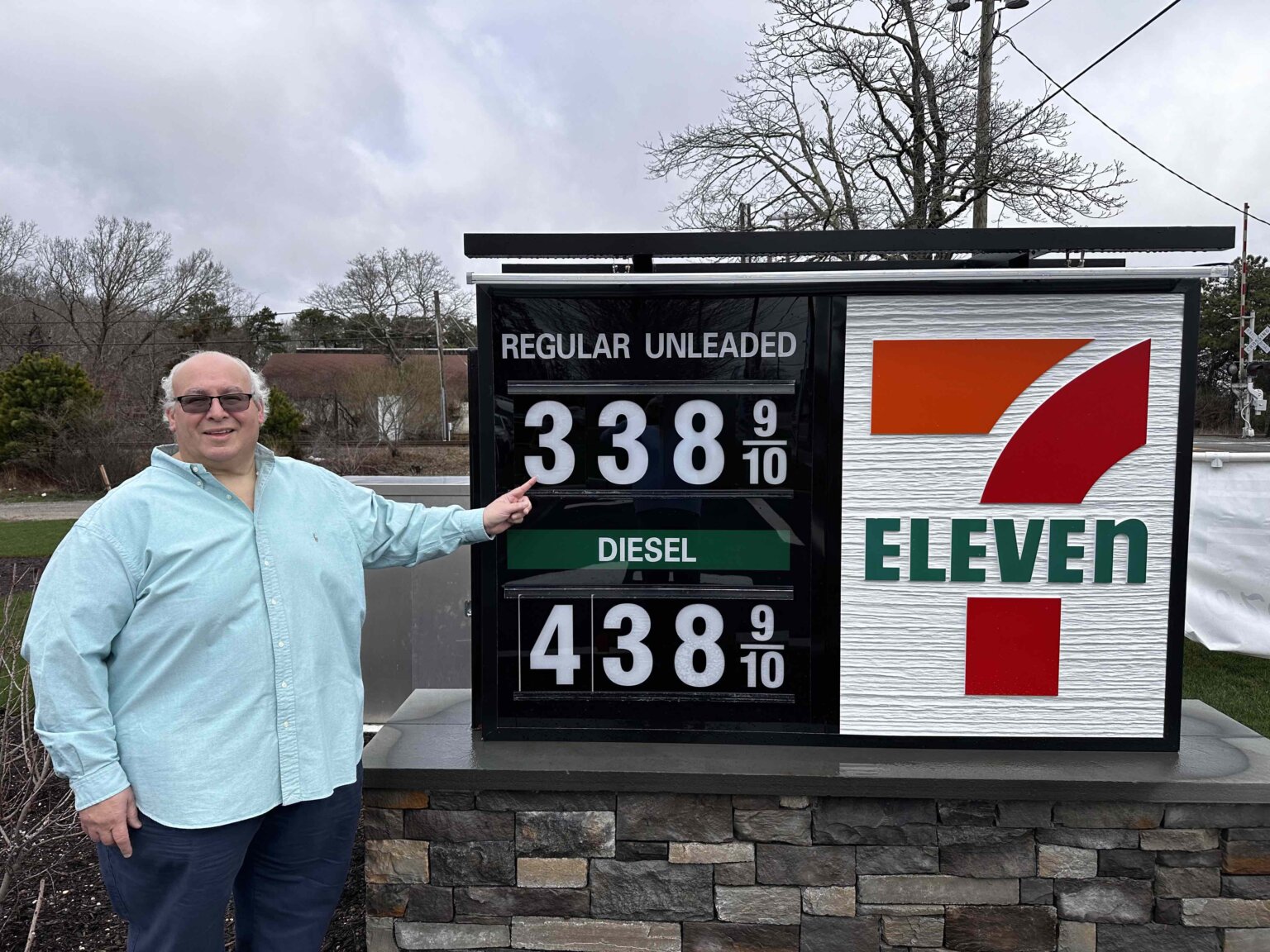 Irwin Krasnow, the developer of the new 7-Eleven gas station in Westhampton Beach, shows off the low gas prices.