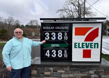 Irwin Krasnow, the developer of the new 7-Eleven gas station in Westhampton Beach, shows off the low gas prices.