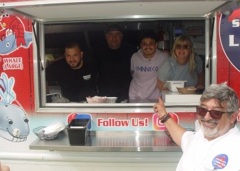 Marco Barrila of Shinnecock Lobster Factory points to his team in the food truck