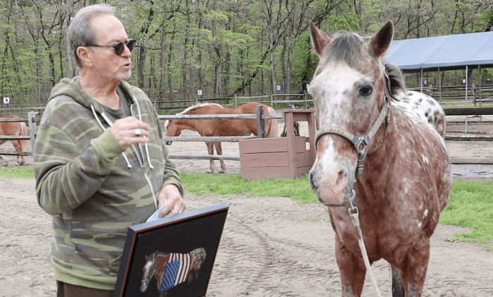 John Melillo shows Cajun the horse his portrait