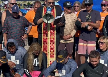 Father Constantine Lazarkis giving the blessing of the water with the Surfers Healing team at Ponquogue Beach