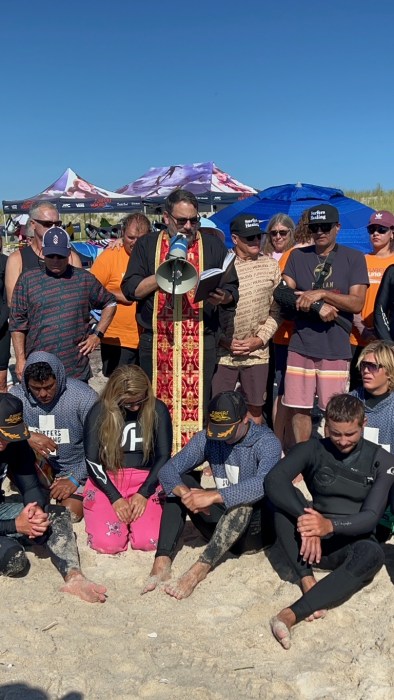 Father Constantine Lazarkis giving the blessing of the water with the Surfers Healing team at Ponquogue Beach