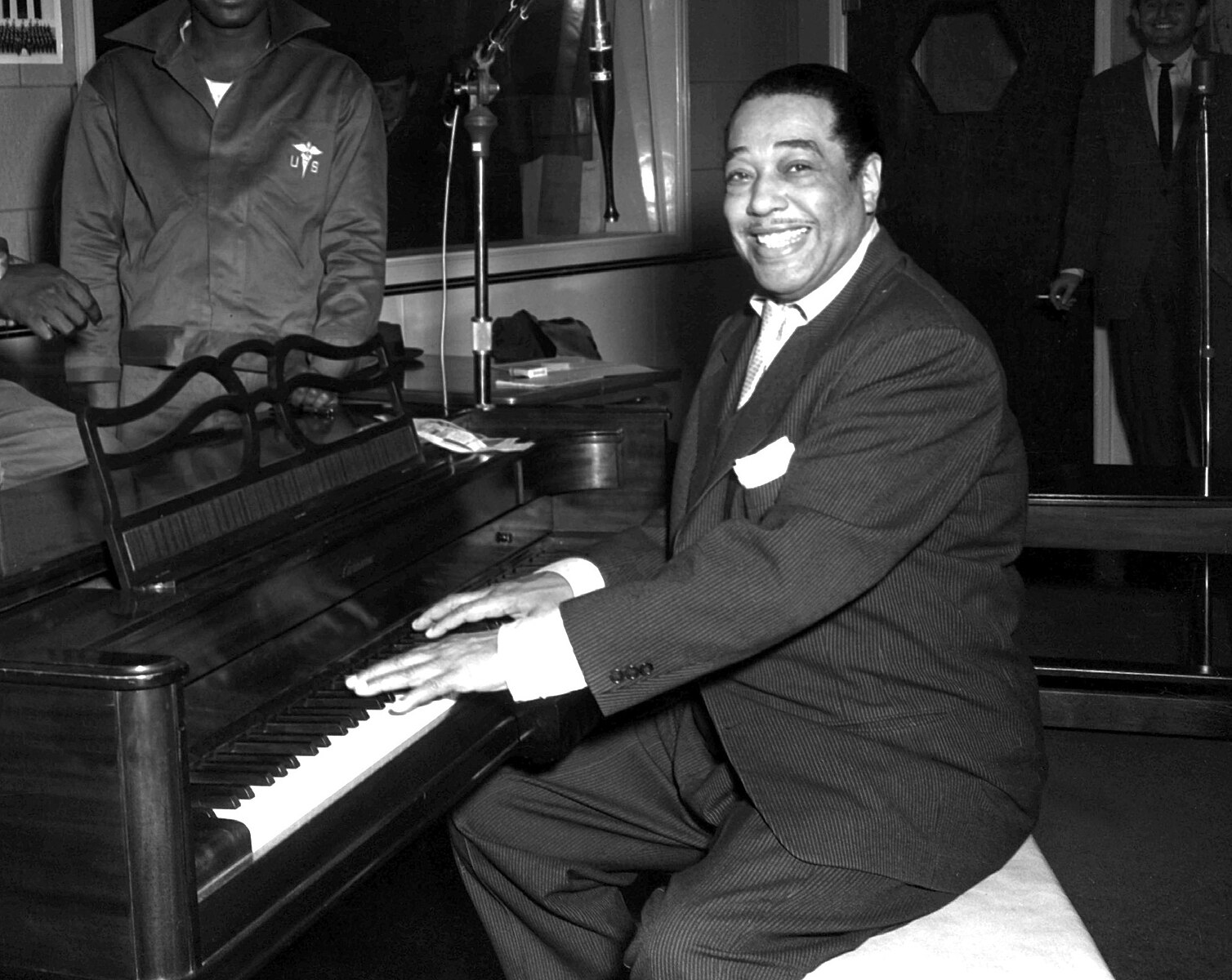 Duke Ellington, a famous jazz musician, poses with his piano at the KFG Radio Studio. KFG is Fitzsimons Army Medical Center's radio station.