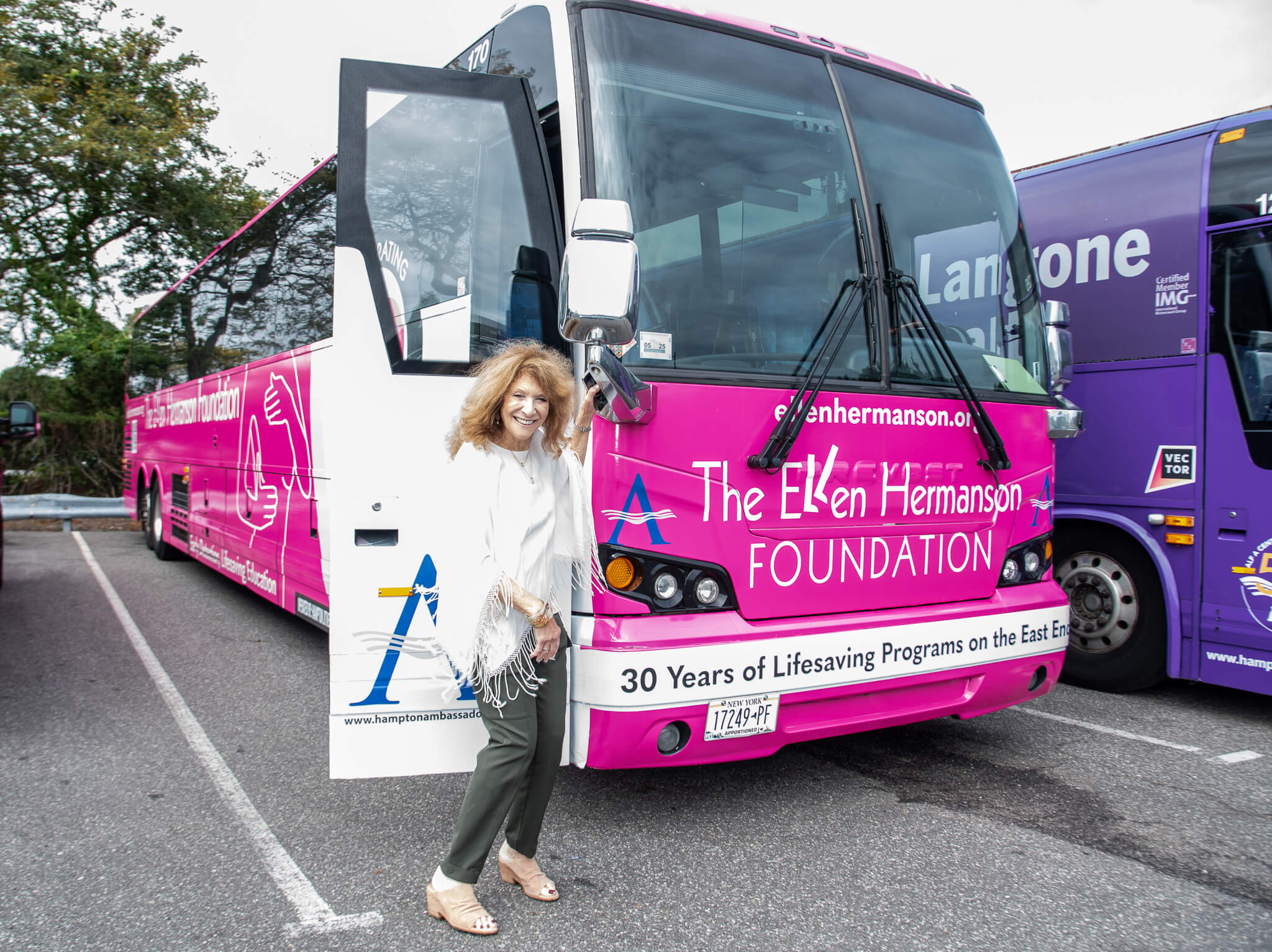 Julie Ratner in front of the [pink-clad Hampton Jitney (Lisa Tamburini) - Ellen Hermanson Foundation and Hampton Jitney