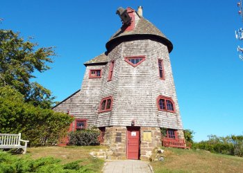 The windmill at Stony Brook University's Southampton campus. A sign on the door reads: 