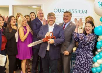 FCA’s Ryan Kiser (holding scissors) is flanked by FCA President and CEO Dr. Jeffrey Reynolds (left), Suffolk County Executive Edward P. Romaine (right) and FCA staff and supporters.