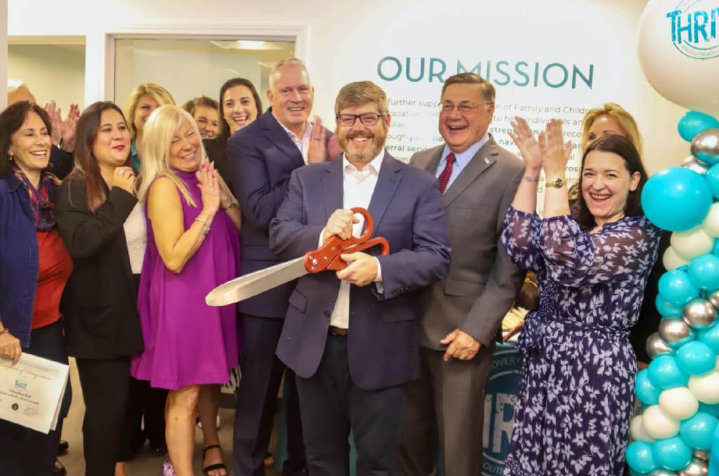 FCA’s Ryan Kiser (holding scissors) is flanked by FCA President and CEO Dr. Jeffrey Reynolds (left), Suffolk County Executive Edward P. Romaine (right) and FCA staff and supporters.